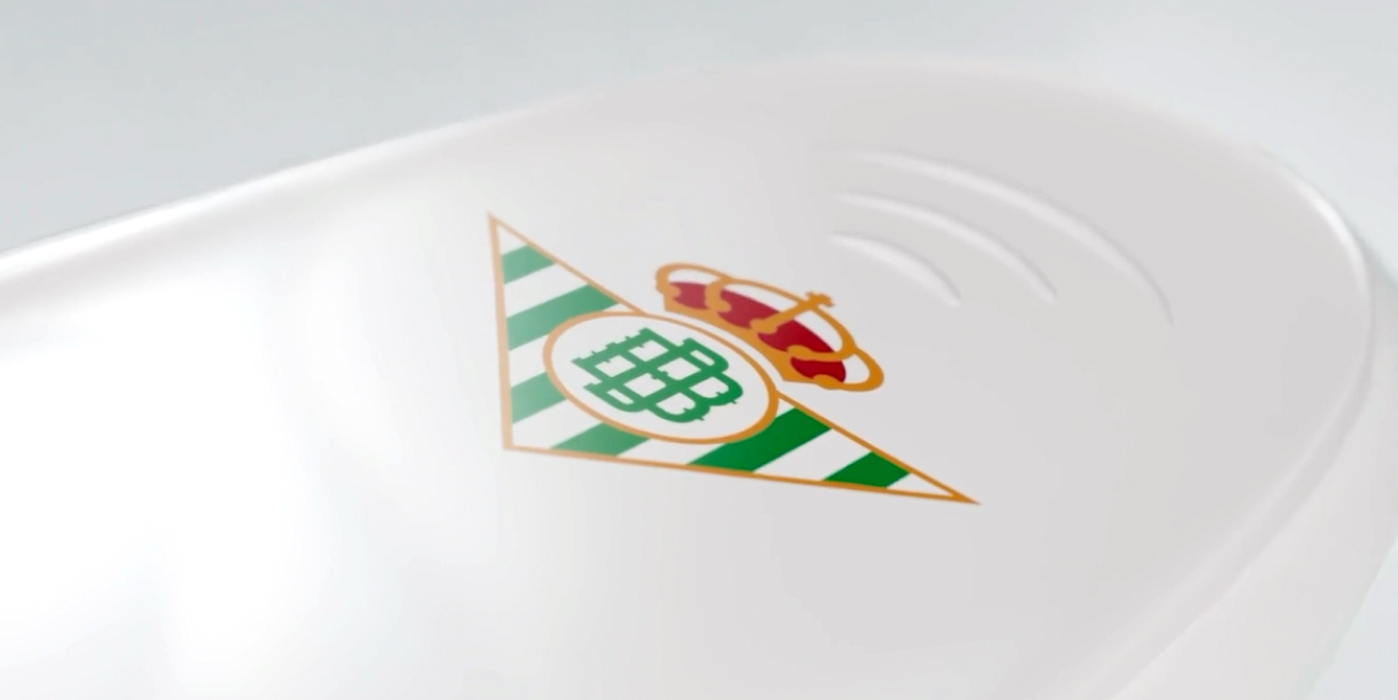 Cinematic close-up of the Real Betis Balompié crest on a flowing white jersey.