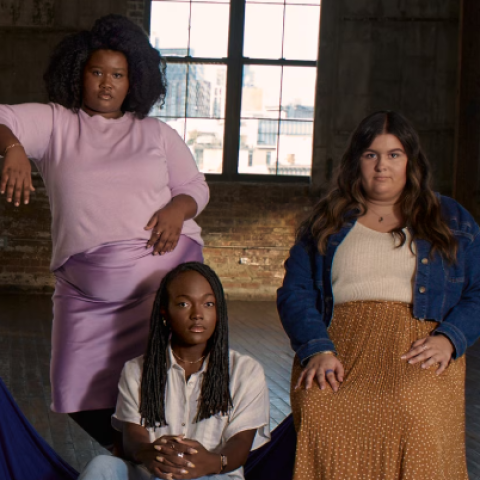Three young women of diverse body types pose together in a studio setting for Dove’s “The Cost of Beauty” campaign.