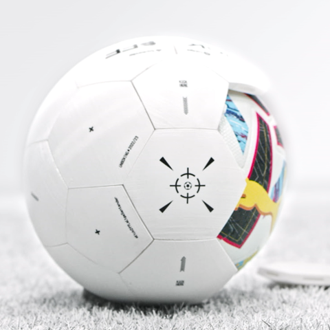 Side angle of LaLiga football placed on artificial turf with loose detached panel pieces nearby.