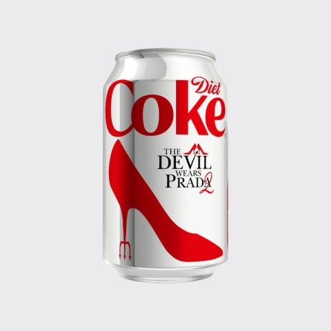 A limited edition Diet Coke can featuring a collaboration with The Devil Wears Prada 2, decorated with a bold red stiletto heel graphic and a small red devil's pitchfork detail, on a light grey background