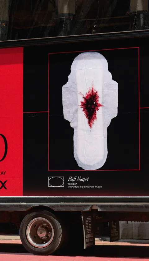 A Kotex 'Art's Missing Period' mobile billboard truck parked in Times Square, New York. The bold red and black display features the campaign title alongside 'Untitled' by artist Rafi Naqvi — an embroidery and beadwork piece on a sanitary pad — with a note reading 'Taken Down Due To Online Abuse 2023'. A QR code directs passersby to visit the virtual gallery. The billboard reads 'The Censored Art of Menstruation — Now on Display